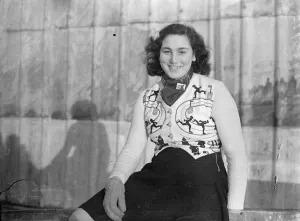 Her sport adorns her dress. Miss Joan Burleigh, who wore an ingenious dress that