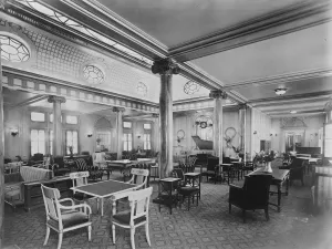 SS Paris The Lounge ( a row of pillars along centre of room, table with four chairs