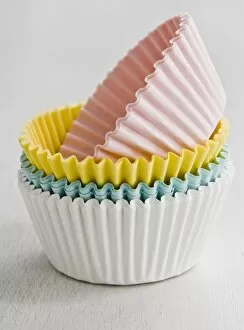 Inspiration Collection: Stack of coloured paper cake and muffin cases credit: Marie-Louise Avery / thePictureKitchen
