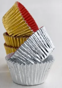 Stack of decorative metallic foil cake and muffin cases credit: Marie-Louise Avery