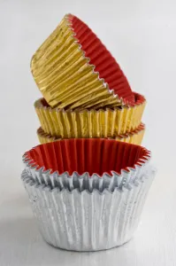 Kitchen Prints: Stack of decorative metallic foil cake and muffin cases credit: Marie-Louise Avery