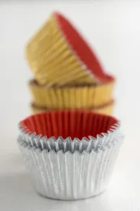 Paper Prints: Stack of metallic muffins cases credit: Marie-Louise Avery / thePictureKitchen