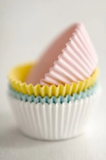 Baking Collection: Stack of pastel coloured muffins cases credit: Marie-Louise Avery / thePictureKitchen