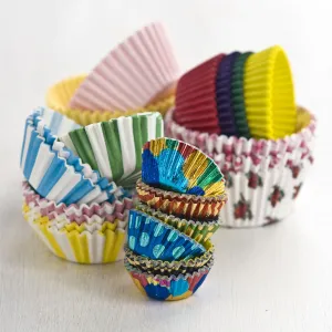 Stacks of decorative paper and foil cake and muffin cases credit: Marie-Louise
