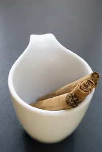 Sticks of cinnamon in small white cup credit: Marie-Louise Avery / thePictureKitchen