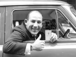 Smiling Prints: Stirling Moss with New Driving Licence after Year of Disqualification. he Celebrated