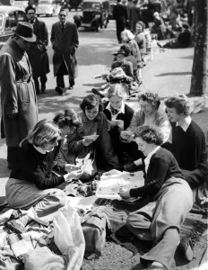 Girls Prints: Students from London University pass the time playing cards in their position in