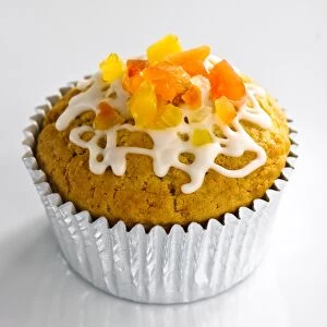 Foods Collection: Sweet muffin in foilcase topped with candied fruit and icing trails credit: Marie-Louise