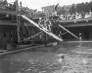 Water Prints: Swimmers enjoying the water chute and diving boards at the open air swimming pool