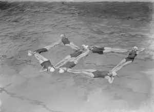 A synchronized swimming group perform a floating display at the opening for the new