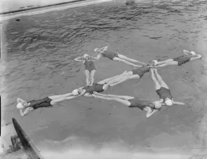 A synchronized swimming group perform a floating display at the opening for the new