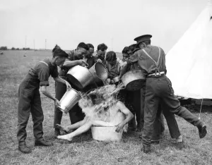 Tent Prints: TA camp having fun bathing with buckets of water in the countryside. August 1938