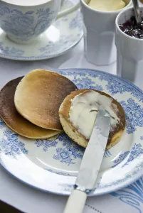 Teatime setting with scotch pancakes and raspberry jam credit: Marie-Louise Avery