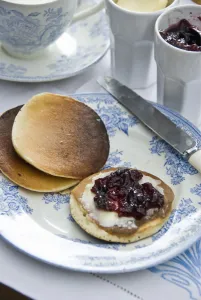 Knife Prints: Teatime setting with scotch pancakes and raspberry jam credit: Marie-Louise Avery