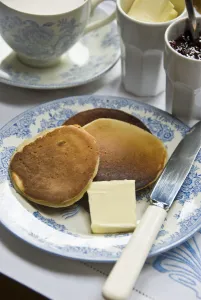 Teatime setting with scotch pancakes and raspberry jam credit: Marie-Louise Avery
