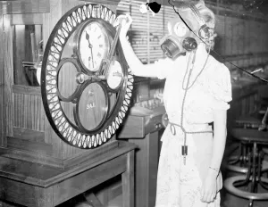 Telephone girls learn to carry on as usual in gas masks. Telephone girls are being