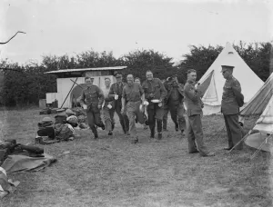 Territorial Army recruits at camp in Chichester, Sussex. Hurrying with cups and plates