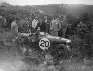 A thrill of the Ulster race. Remarkable photograph of motorcyclists car crashing