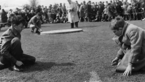 Tinsley Green, Sussex Two small boys engrossed in playing their own game of marbles