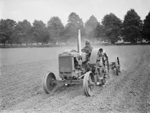Tractor, driver wearing helmet and goggles. 1937