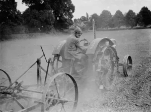 Farm Prints: Tractor, driver wearing helmet and goggles. 1937