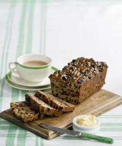 Traditional style fruit tea loaf sliced and served with butter and afternoon tea credit