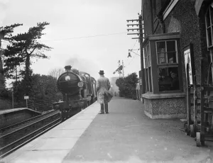 Platform Prints: A train worker sits in the signal box on the train platform. 1936