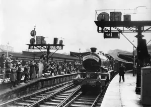 Trainspotters watch and photograph one of the final steam locomotives