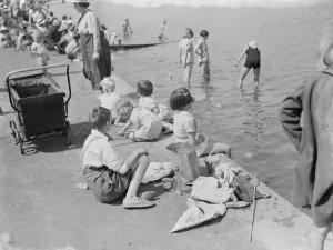 Trippers are out to enjoy the sun and the River Thames on the Gravesend promenade, Kent