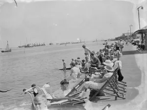 Ships Prints: Trippers are out to enjoy the sun and the River Thames on the Gravesend promenade, Kent