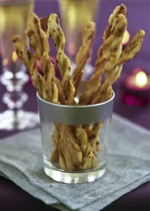 Cooking Prints: Twisted cheese straws in silver rimmed glass in candlelit party setting credit
