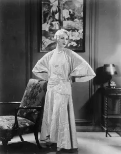 Film Star Prints: Unusual evening frock worn with smart cape coat of same material. Moire treated