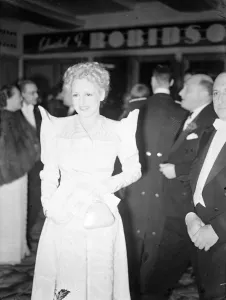 An unusual fashion worn by attractive Mrs Max Milder when she arrived for the opening