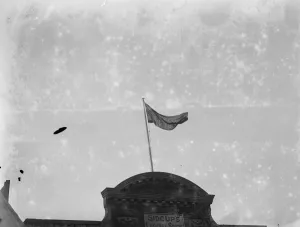 Shop Prints: Unusual flag in over a shop in Sidcup, Kent. 1935