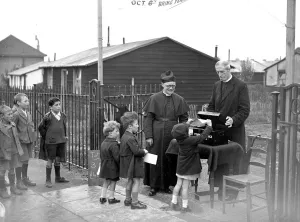 Priest Prints: Vicars beg in street at St Bannabus, Eltham, Kent. 1934