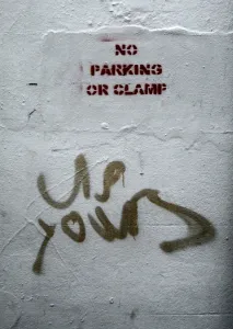 Social Issues Prints: Vulgar graffiti in response to public notice: no parking or clamp