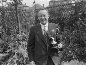 Award Prints: A W Costley, the Secretary of Crayford Horticultural Society, posing with his trophy