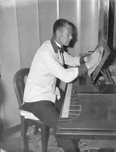 Waiter who strikes a different note, successful composer of music in his spare time