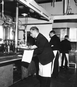 Picture Library Prints: Waiters finish off with tea or coffee as they collect orders during the lunch rush