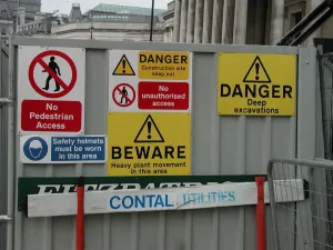 Sign Prints: Warning notices on a metal screen outside a construction site in Trafalgar Square