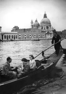 Wearing dark glasses Princess Margaret starts off for her tour of the Grand Canal