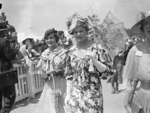 White Parasol And Unusual Hat Fashion At Ascot. Ascot, on Royal Hunt Cup day