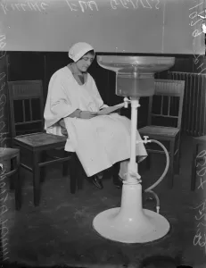 Hospital Prints: White robed figures at Englands first inhalatorium. Fumes that kill the flu germ