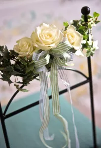 Chair Prints: Three white rooses with stripey ribbons and ivy leaves as decorations tied to chair