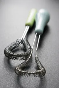 Kitchen Prints: Wire whisks for cookery on dark surface credit: Marie-Louise Avery / thePictureKitchen