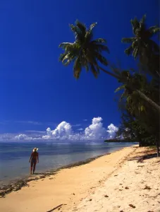 Woman on beach on the island of Morea, near Tahiti