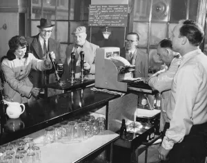 Cheers! Vintage Food And Drink Prints: A woman customer pulls her own pint of beer at The Elephant and Castle, London, England