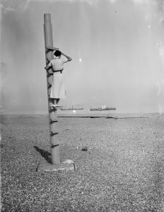 Ships Prints: A woman stands on the outlook post on Dungeness beach in Kent. 1936