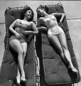 Women sunbathing lying on sunbeds