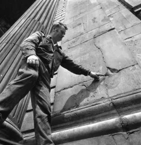 Church Prints: A worker points out the cracks that need repairing to the exterior wall of St Pauls Cathedral